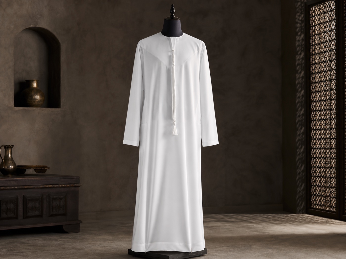 A pristine white Emirati kandura displayed in a heritage atelier